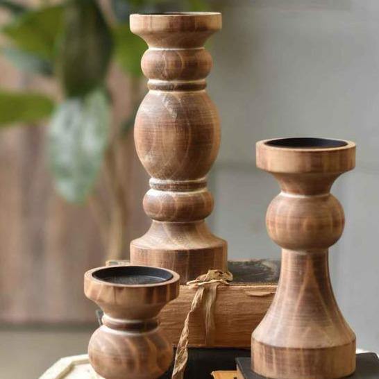 Rustic pillar candle holders in natural wood for use as home decor accents 