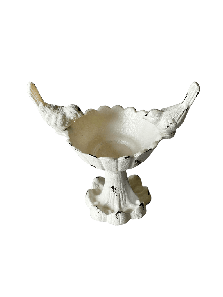 Cast iron bird bath on pedestal with two small birds on either side. Scalloped edge and antique white finish with distressed details.