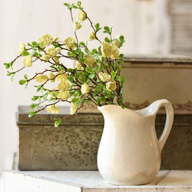 Small stone pitcher with yellow roses.